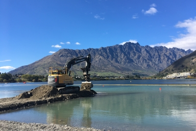 Oscar from Fulton Hogan, at Frankton, Queenstown - Excavator operator builds rock causeway into lake in preparation for dredging operations.