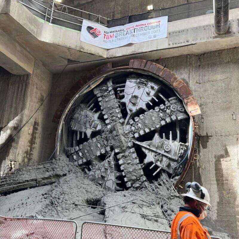 Shift engineer Taio Pou in front of the Tunnel Boring Machine shortly after it broke through the earth at Aotea